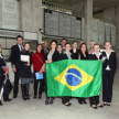 Los Estudiantes posando con la bandera brasileña en la planta baja del edificio judicial.